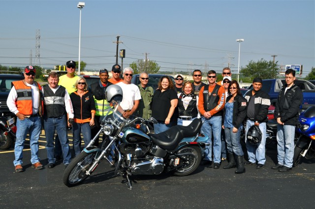 IMCOM riders pose with a Harley before taking off