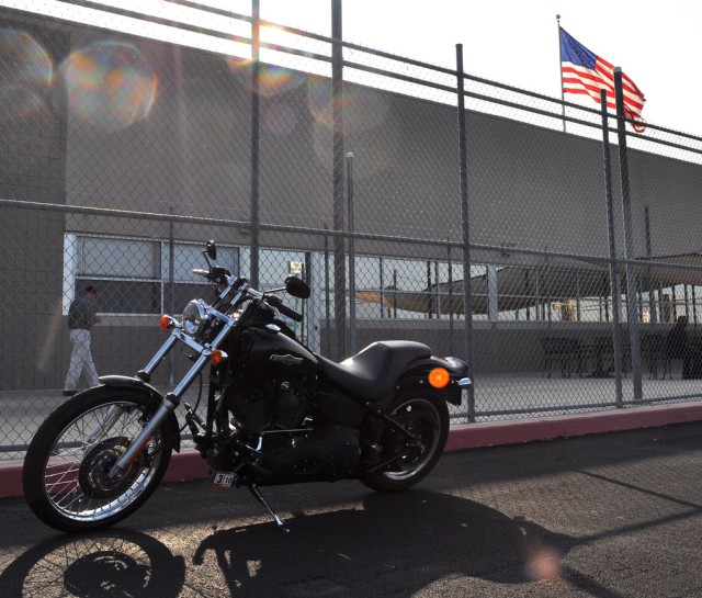 A Harley waits in front of the IMCOM HQ leased space as the American flag flies in the background. 