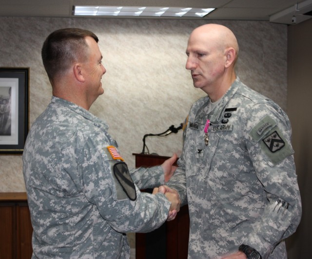 Funk congratulates McManigal on Legion of Merit