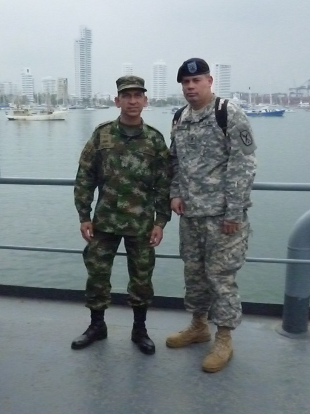 Sgt. 1st Class Francisco Mendez Military Personnel Exchange Program participant stands with Sgt. Maj. Jose Adolfo Reyes sergeant major of the Colombian armys Sergeant Major Academy.   