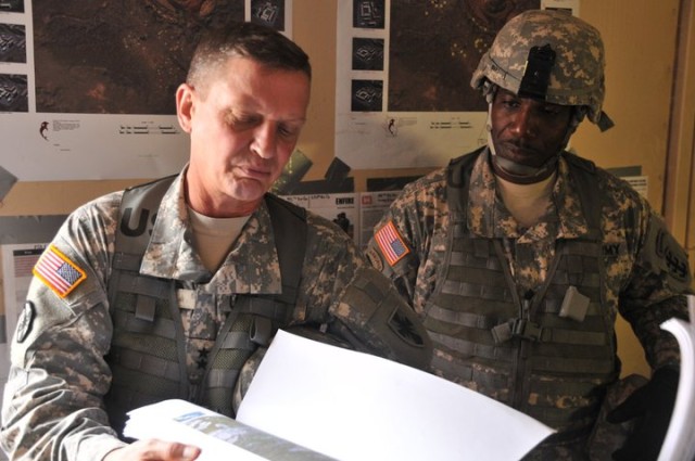 Maj. Gen. Terry and Command Sgt. Maj. Roy Ward look at maps