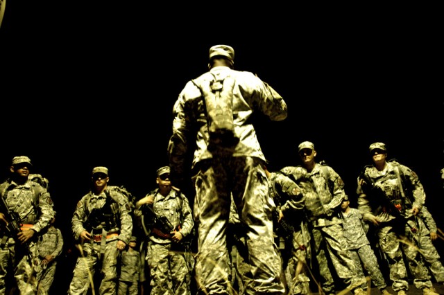 Soldiers prepare for the 12-mile road march at the IMCOM Best Warrior Competition