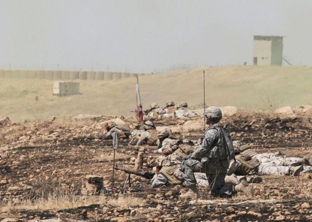 Observing from beside Iraqi soldiers.