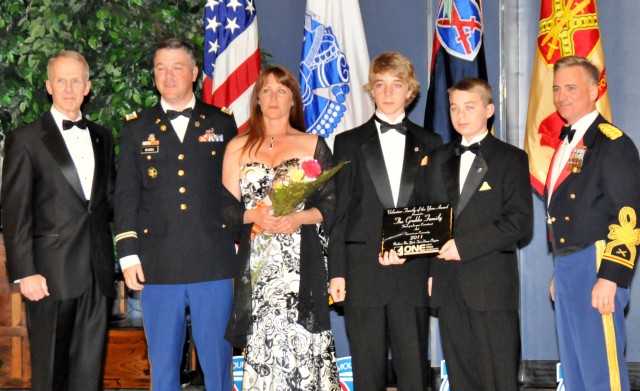 From left, retired Lt. Gen. James L. Campbell, former 10th Mountain Division (LI) commander presented the 2011 AUSA Volunteer Family of the Year award to Lt. Col. Lee Grubbs, former commander of 1st Brigade Special Troops Battalion, 1st Brigade...