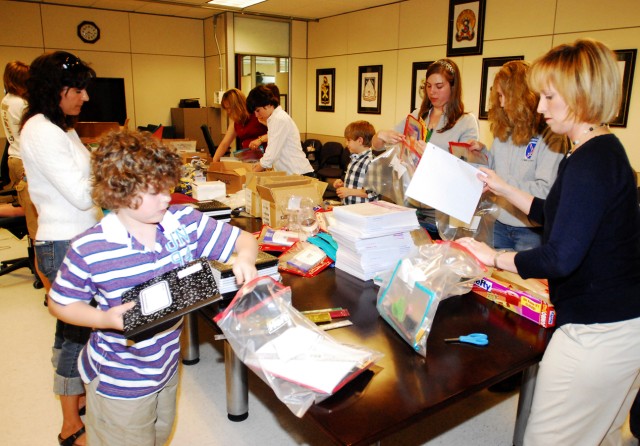 Family Members of Soldiers from 3rd Brigade Combat Team pack school supply kits June 5 in support of Operation Education. The kits will be mailed to Soldiers, who are currently deployed to southern Afghanistan, where they will be handed out to school...