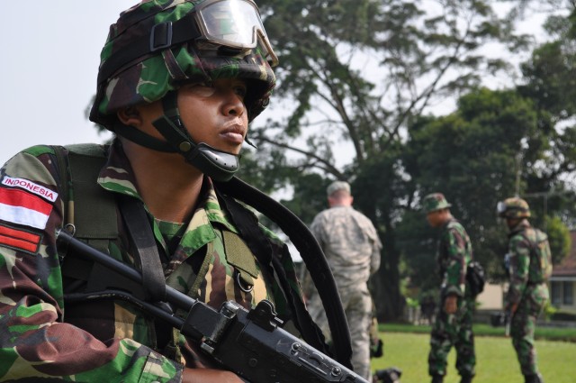 Indonesian Armed Forces private provides security for his fellow Soldiers