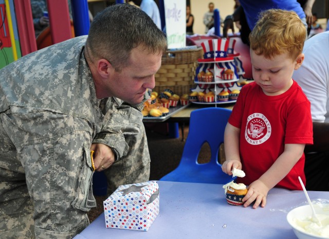 Lt. Col. Guttormsen enjoys watching son create a cupcake masterpiece