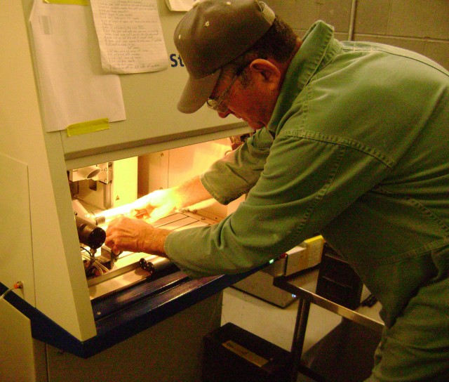 CAAA Employee loads a decoy flare into the laser etcher.