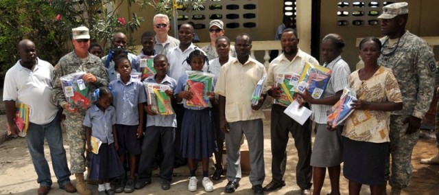 Col. Donnelly and Stansberry pose with children and teachers