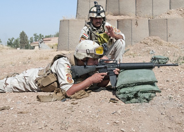 Iraqi NCO observes Iraqi soldier on the firing range