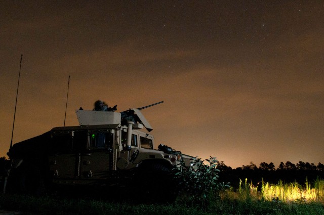 Two paratroopers with the 82nd Airborne Division’s 1st Brigade Combat Team pull security at a mock village during a joint operational access exercise June 27, 2011, at Fort Bragg, N.C.  The soldier at