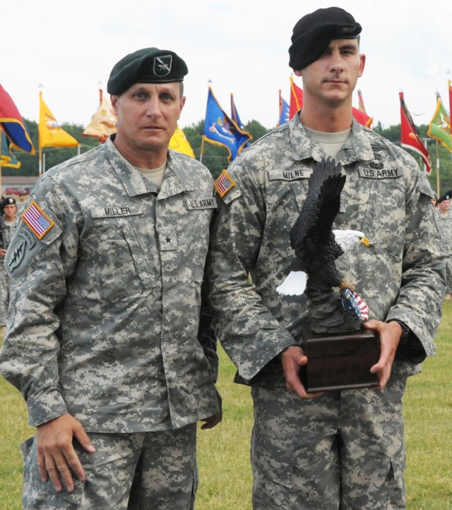 Brig. Gen. Harry E. Miller Jr., left, senior commander Fort Drum, congratulates Staff Sgt. Douglas A Milne, right, 10th Mountain Division NCO of the Year, during the Mountainfest celebration June 23 on Fort Drum. Milne went on to win runnerup in the ...
