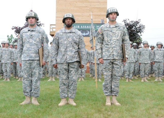 The top three Air Assault School graduates stand in front of their classmates at the Light Fighter School. From left are Spc. John F. Meister, Distinguished Honor Graduate; Sgt. 1st Class Jimmie L. Blockett, Honor Graduate; and Sgt. Bror W. McWhinney...