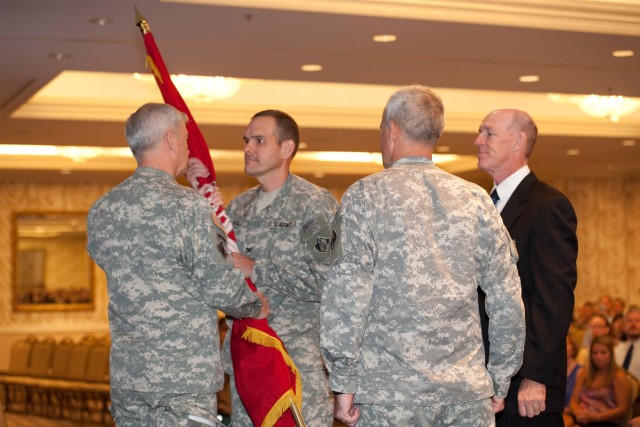 Maj. Gen. Michael Walsh passes the Corps of Engineers flag to Col. Hall