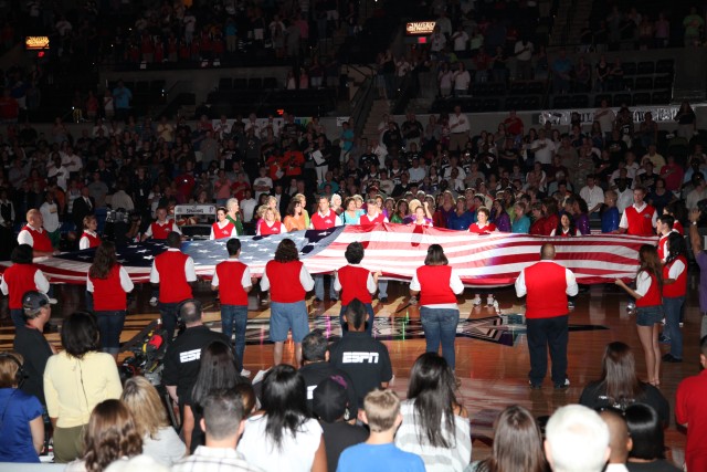 Army Teen Panel presents flag at WNBA Game