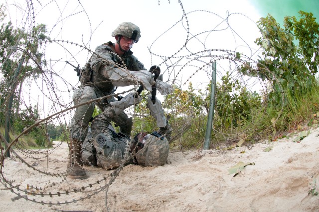 Airborne engineers breach a wire barrier