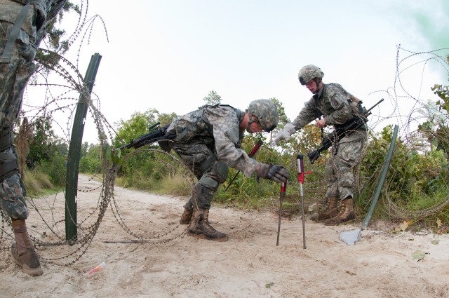 Airborne engineers breach a wire barrier