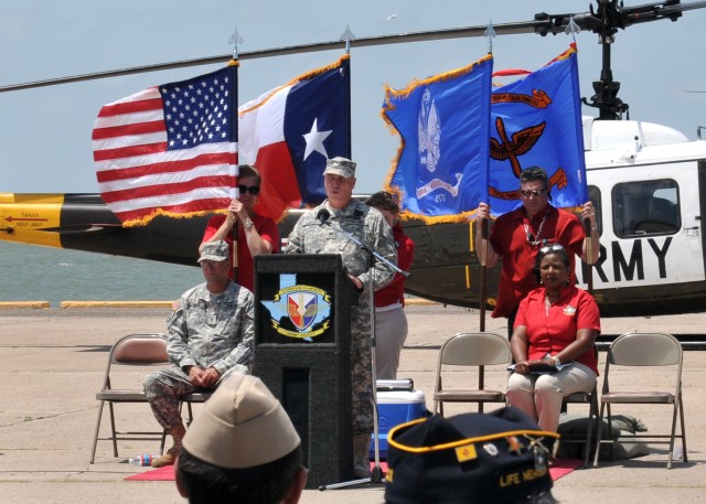 Col. Christopher B. Carlile, Commander, Corpus Christi Army Depot, addresses the crowd gathered to honor the last UH-1H Huey to leave the depot.