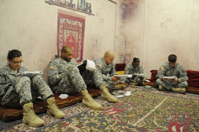 From left, Pfc. Mila Kisic, Pfc. Chris Adams, Pfc. Rodolfo Lozada, Pfc. Ashley Tyson and Spc. Alex Sisson, all students in Fort Drum's Mountain Language Training Academy course, study for an exam in a mock Afghan dining room on post. The students...