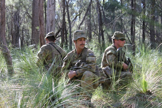 Australian Defense Force pauses during a patrol 