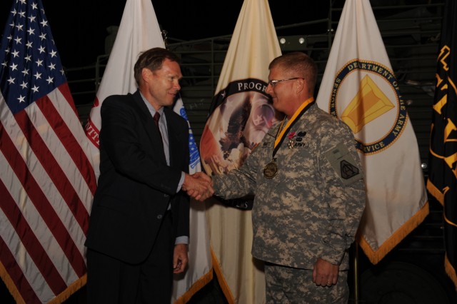Dave Dopp congratulates Col. Robert Schumitz