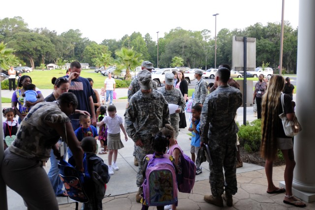 Soldiers, Families bring kids to school for first day