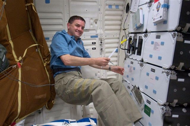 Walheim performing temperature checks on Space Shuttle Atlantis