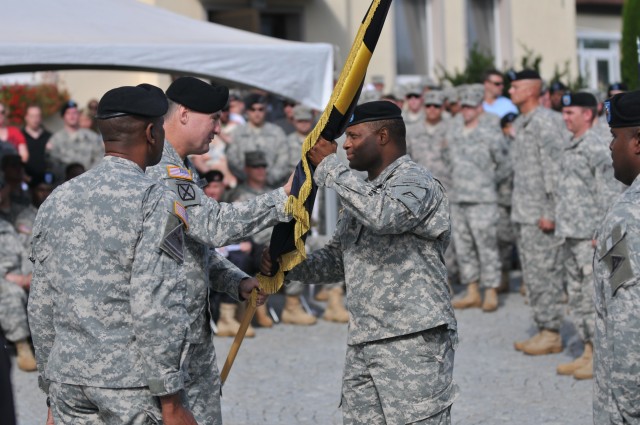 Command Sgt. Maj. Louis Tinsley accepts colors from JMRC commander, Col. John M. Spiszer