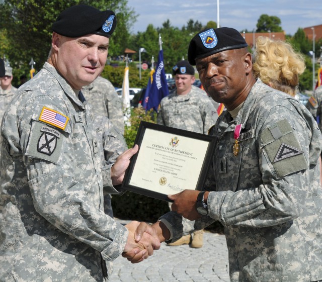Command Sgt. Maj. Frank Graham receives retirement certificate from JMRC comander