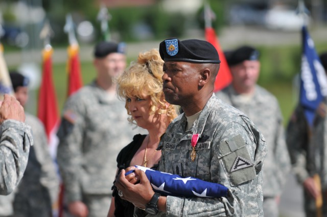 Command Sgt. Maj. Frank Graham receives flag flown over Hohenfels, Germany military community.