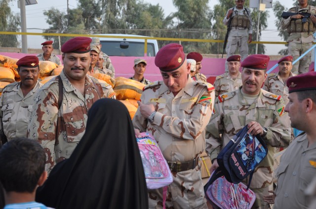 17th Iraqi Army Division leaders hand out school supplies