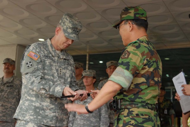 III Corps is presented with honorary baton