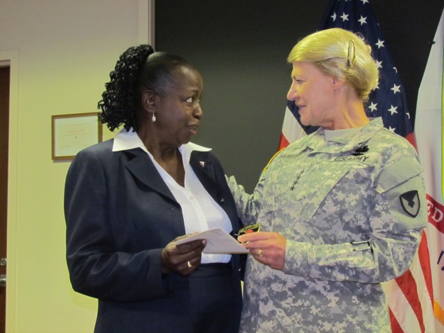 Gen. Ann Dunwoody Presents Rosa Smalls With A Four-Star Letter And Coin