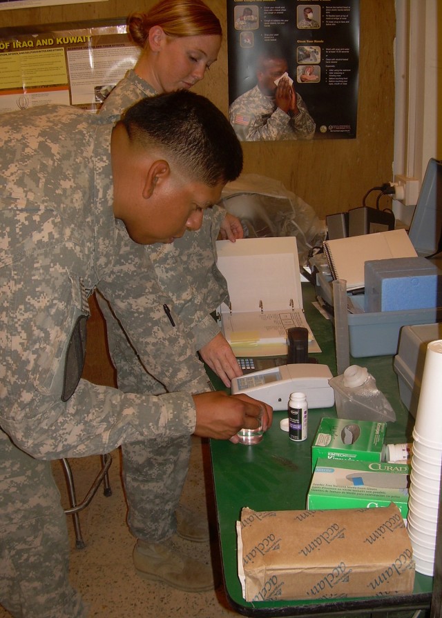 Soldiers analyze water sample