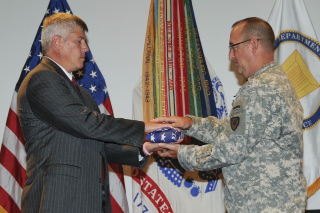Retiring Deputy Director John Oxford receives Flag