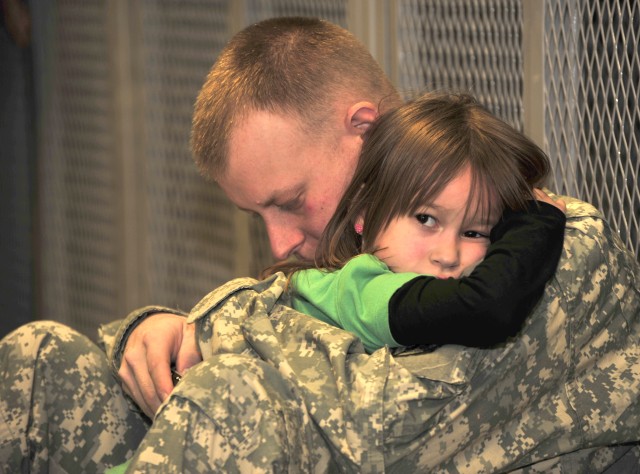 Pfc. Chris Paterson holds his 6-year-old daughter Aliva before deploying to Afghanistan from Fort Drum on Jan. 9, 2010. Paterson is an infantryman assigned to C Company, 2nd Battalion, 22nd Infantry Regiment, 1st Brigade Combat Team. His battalion wo...