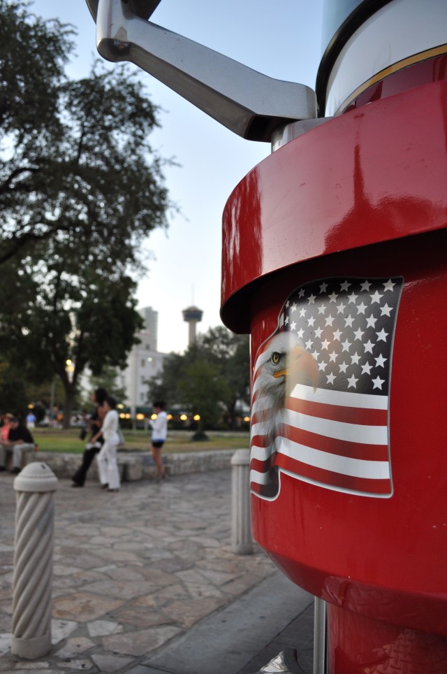 An American eagle decal adorns a San Antonio Fire Department fire truck as the Tower of the Americas stands in the background.