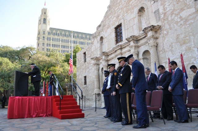 Rabbi Aryeh Scheinburg leads a closing co-prayer, followed by Moderator of the Curia Rev. Martin Leopold, as San Antonio city and military leaders bow their heads.