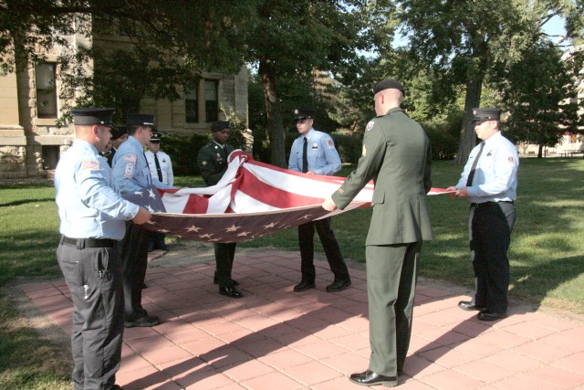 Soldiers, firefighters fold flag on 9/11