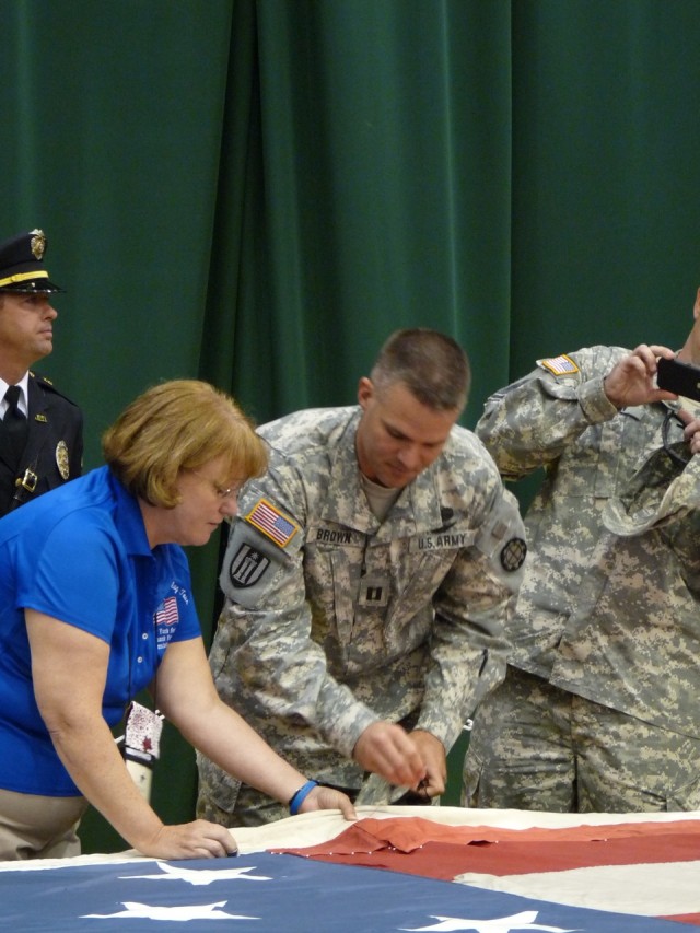 Soldiers, first responders, citizens stitch 9/11 memorial flag in Joplin