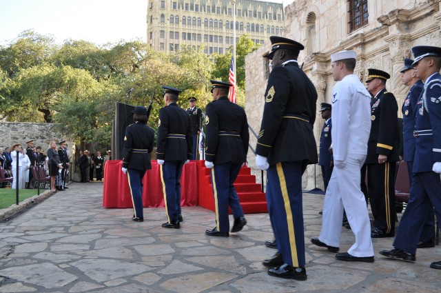 IMCOM Command Sgt. Maj. Neil Ciotola stands at attention as the Joint Service Color Guard advances to retire the colors.
