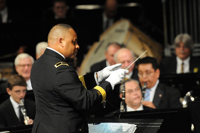 Commanding General of the 85th Support Command, Brig. Gen. Gracus Dunn conducts "Stars and Stripes Forever" with the Buffalo Grove Symphonic Band