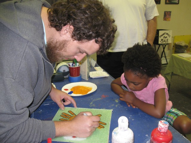 Greg Miller working with children in his art classes.