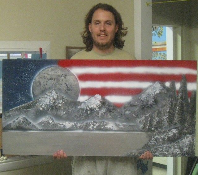 Miller holding the artwork he submitted to the Wounded Warrior Art Program.