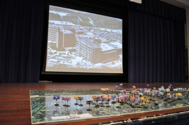 A model of Joint Base San Antonio BRAC 2005 projects is displayed in front of a video depicting each project's construction progress at a press conference Sept. 14.