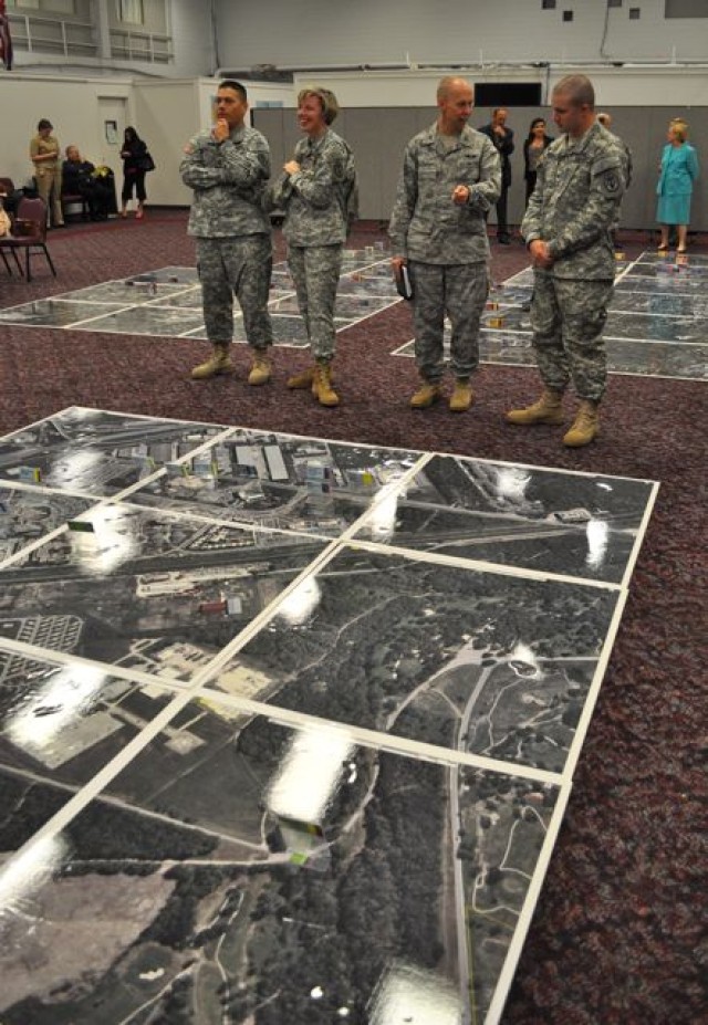 JBSA military members observe a model of BRAC 2005 projects in San Antonio.