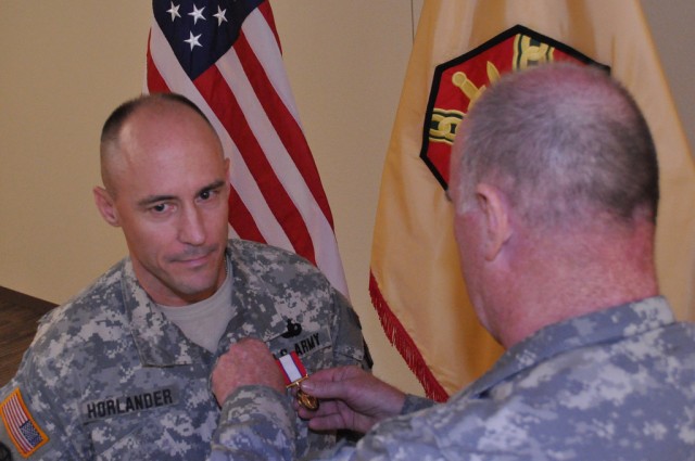 IMCOM Commanding General Lt. Gen. Rick Lynch pins a Distinguished Service Medal on Brig. Gen. Thomas Horlander, honoring his three years of outstanding service as director of resource management/G8.