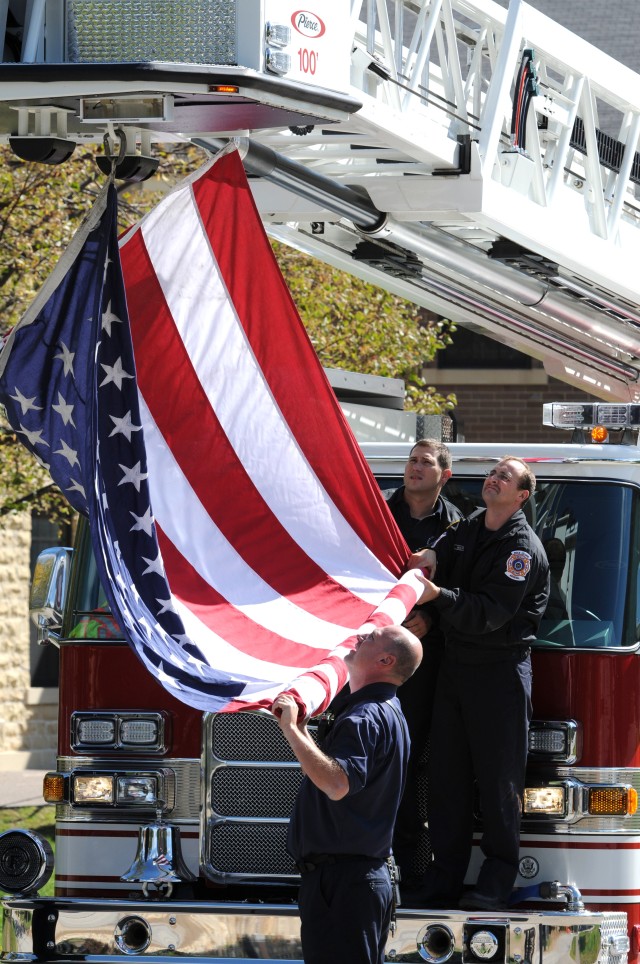 Firefighters unfurl flag honoring fallen Soldier