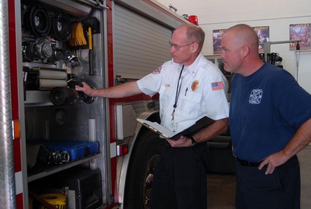 Capt. Tracy Watts And Doug Jones Inspect Fire Truck Inventory