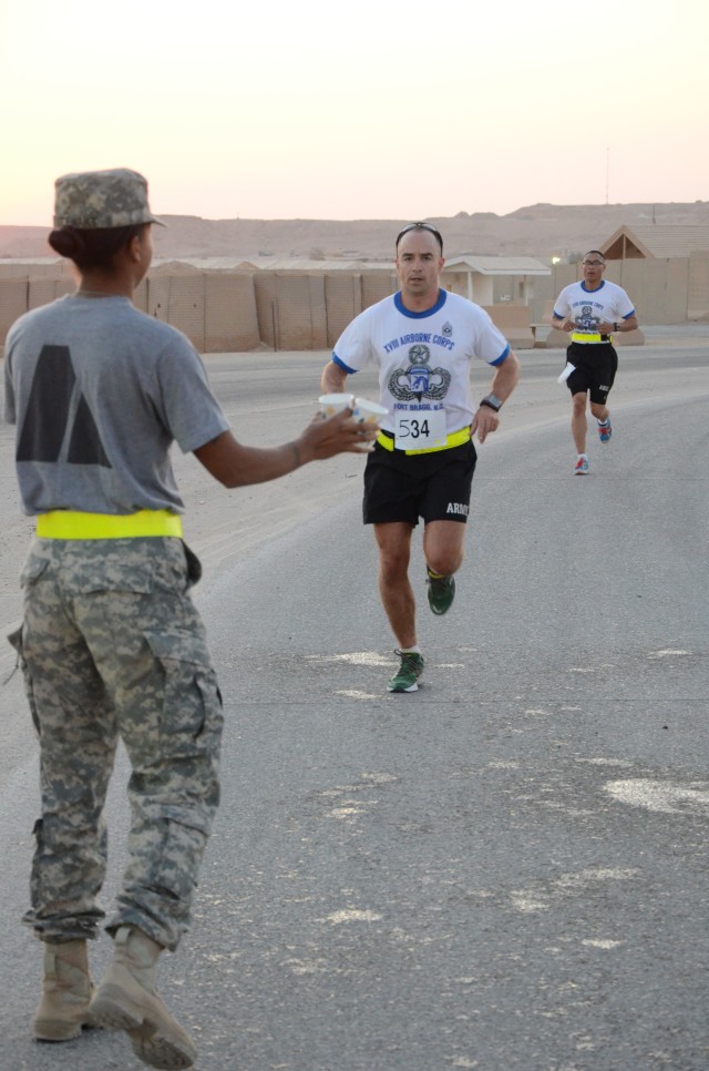 Service members deployed to Iraq shadow run the Army Ten-Miler